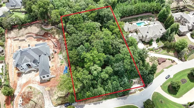 an aerial view of a house with a yard and garden