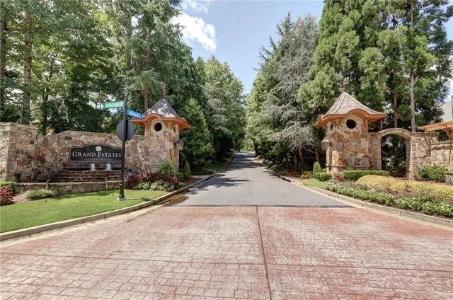 a front view of house with a yard and large trees