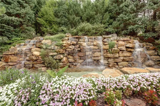 a view of a yard with wooden fence