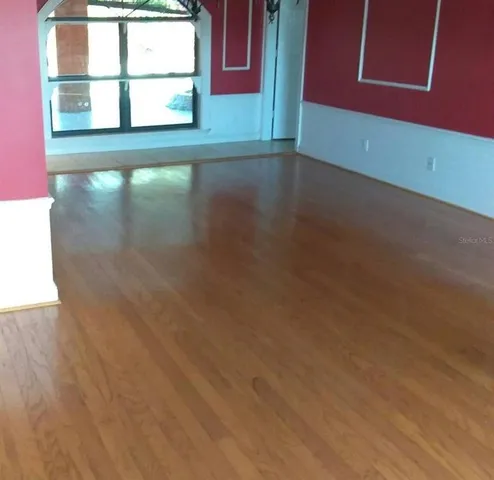 a view of a room with wooden floor and windows