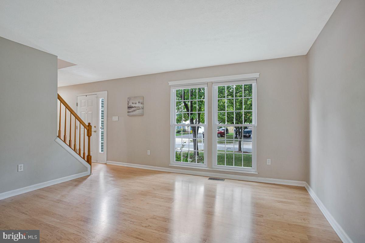 8401 Triple Crown Road Bowie, MD 20715 - Photo 5 of 44 Living room with large windows = plenty of light