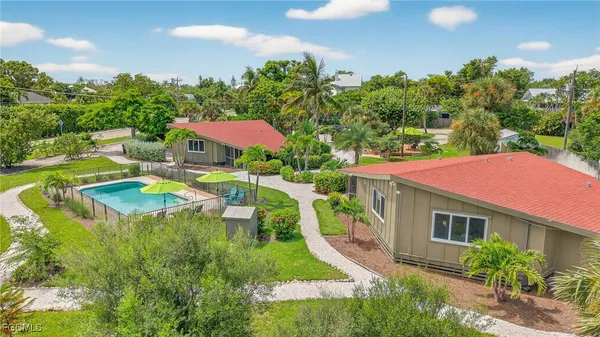 a view of a house with a yard and sitting area