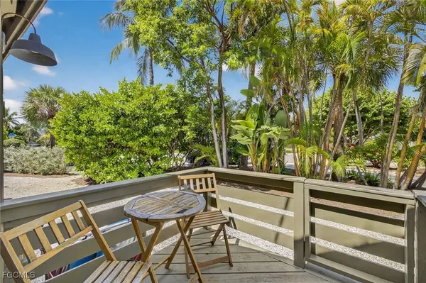 a view of a chairs and table in a balcony