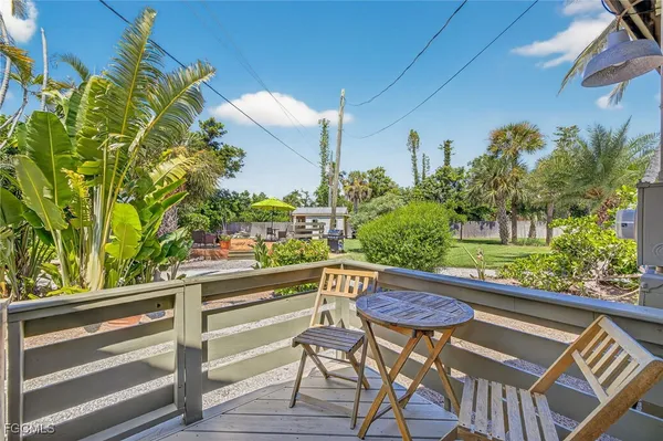 a view of a chairs and table in the balcony
