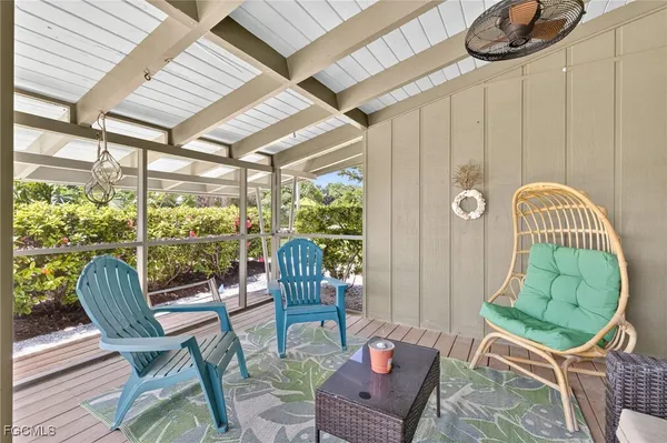 a living room filled with furniture and a floor to ceiling window