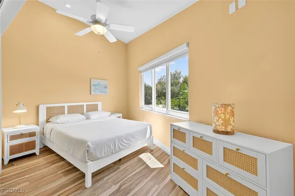 a bedroom with a large bed and a window