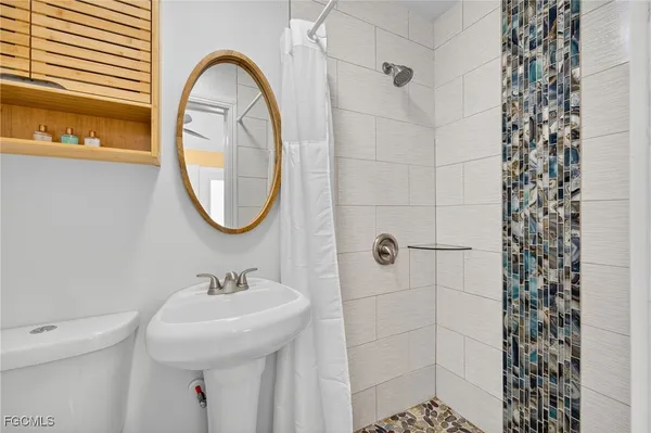 a bathroom with a sink a mirror and a shower