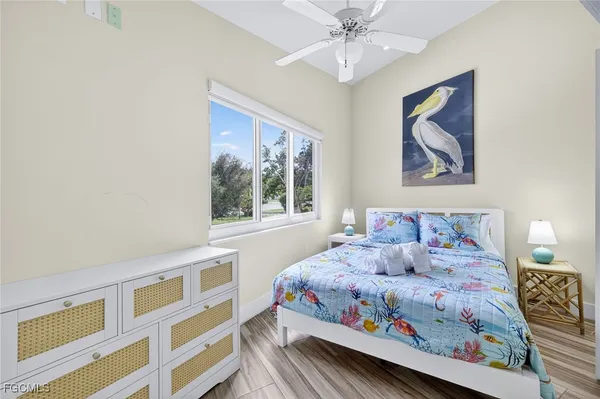 a bedroom with a bed and a painting on the wall