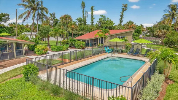 a view of a backyard with a garden and deck