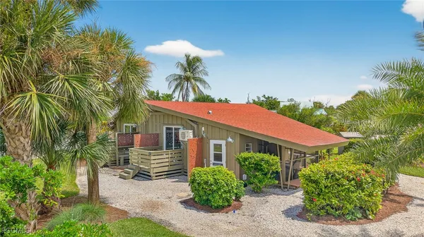 a view of a house with a yard and plants