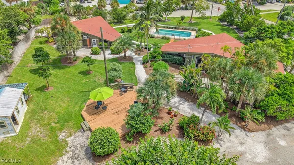 an aerial view of a house with swimming pool garden and patio