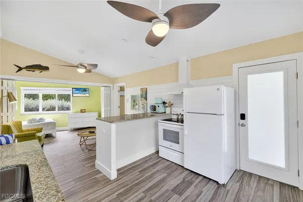 a kitchen with counter top space and wooden floor