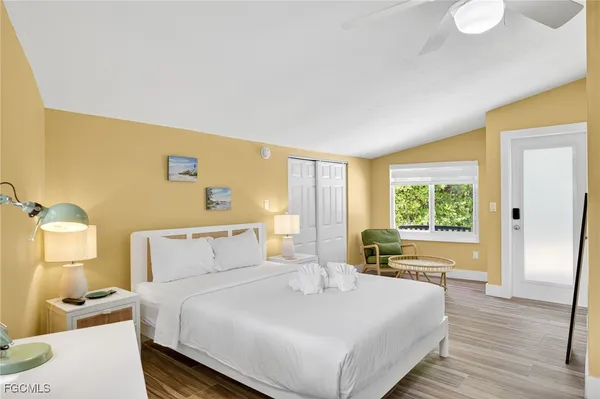 a bedroom with a bed and wooden floor