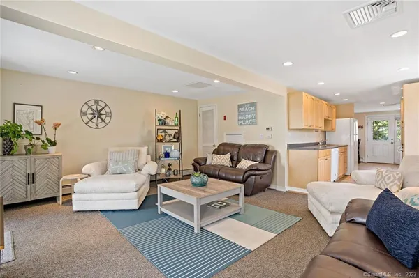 a living room with furniture and kitchen view