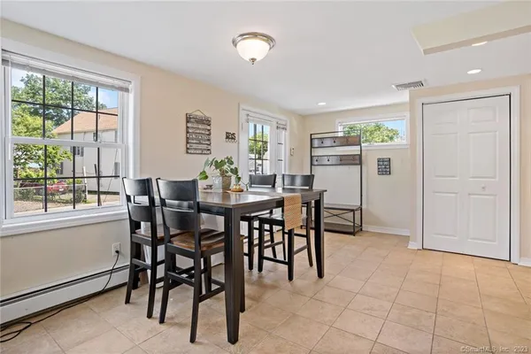 a view of a dining room with furniture and a window