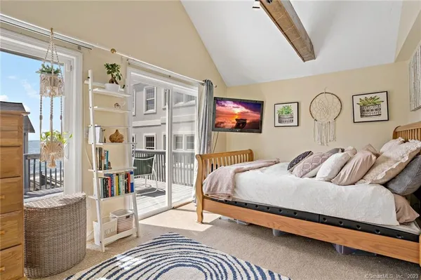 a bedroom with a bed couch and a window