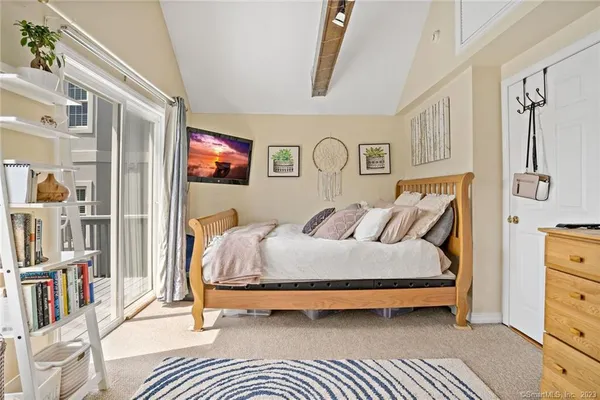 a bedroom with a bed dresser and a window