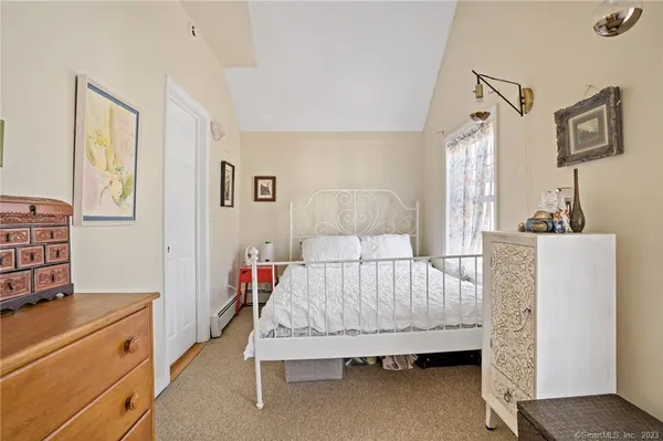 a bed room with a bed and a chair