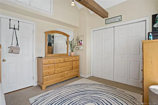 a view of a bedroom with closet and cabinet