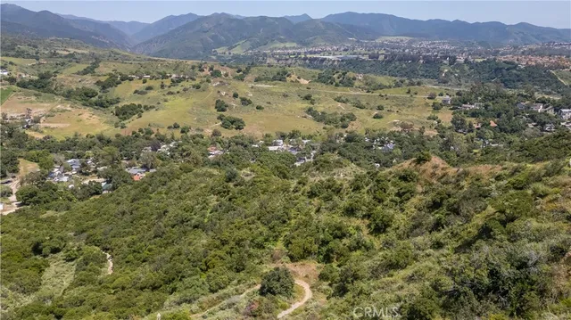 a view of a lush green hillside and houses