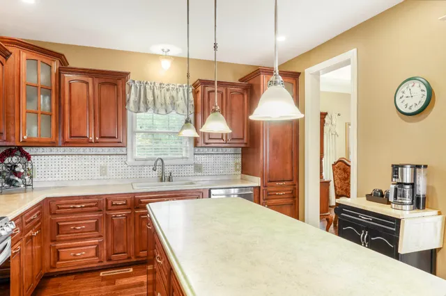 a kitchen with stainless steel appliances a sink a stove and a refrigerator