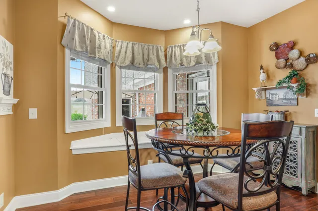 a view of a dining room with furniture wooden floor and chandelier