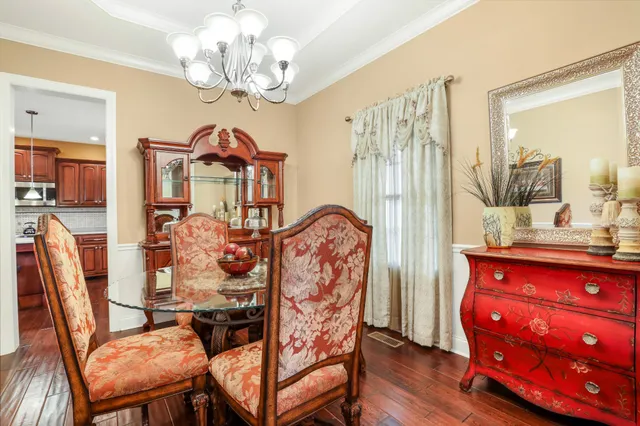 a view of a dining room with furniture and chandelier