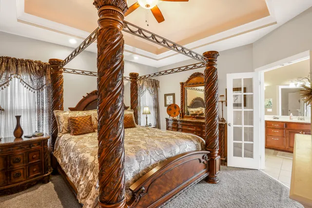 a bedroom with a bed next to a window