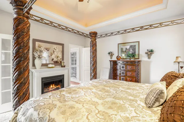 a bedroom with a bed and a fireplace