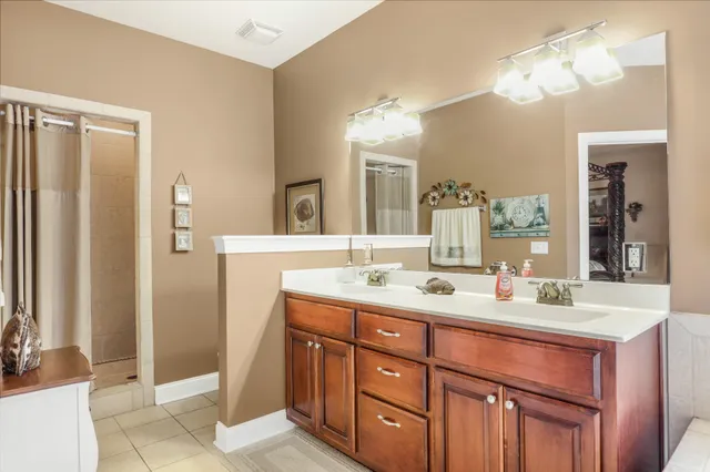 a bathroom with a sink double vanity and a mirror