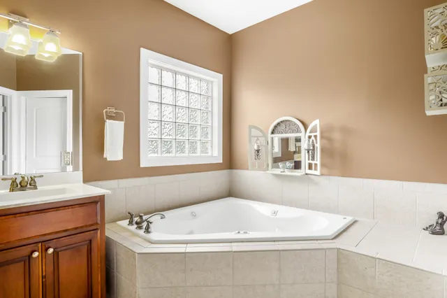 a bathroom with a bathtub sink and window