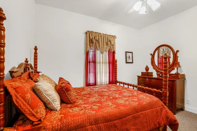 a bed sitting in a bedroom next to a window