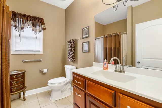 a bathroom with a sink a toilet and a mirror