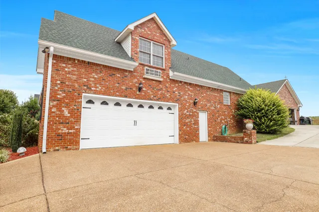 a view of a patio with table and chairs under an umbrella