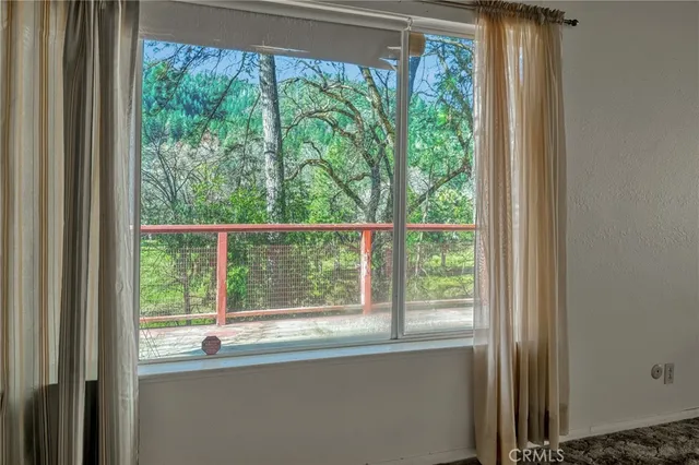 a view of a room that has a bed and a window