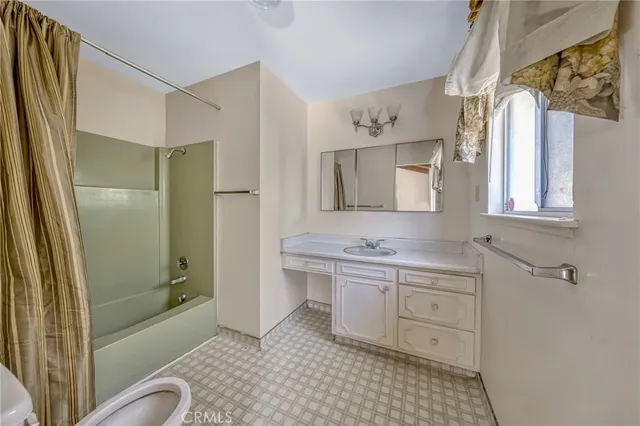a spacious bathroom with a shower sink and mirror