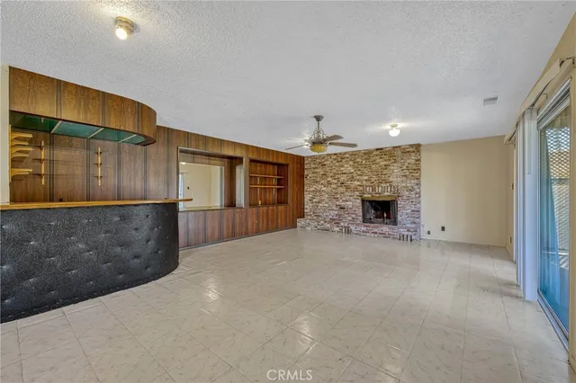a view of empty room with a fireplace