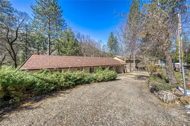 a view of a house with a yard and potted plants