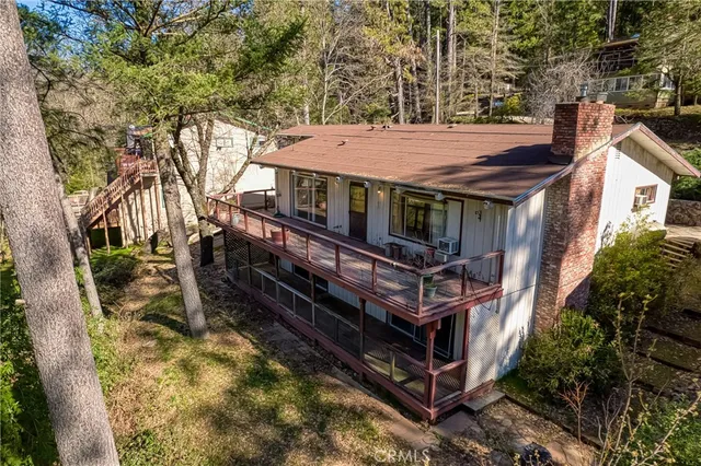 a view of a small house with roof deck front of house