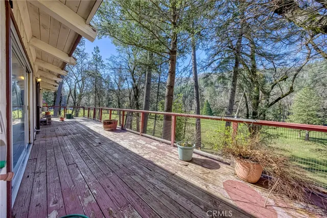 a view of a balcony with wooden floor and outdoor space