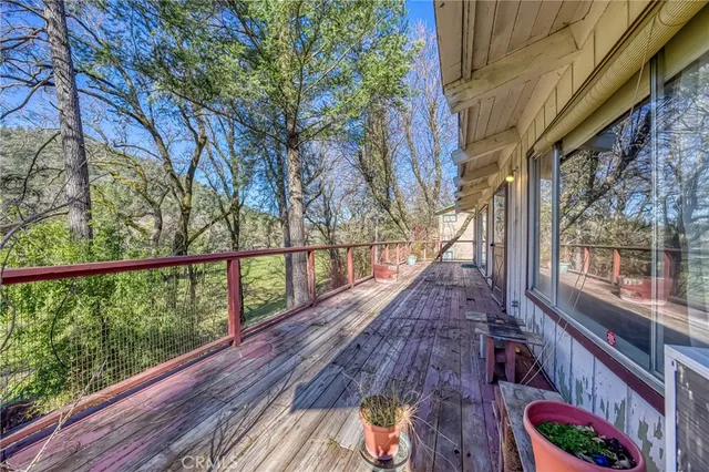 a view of balcony with wooden floor and fence