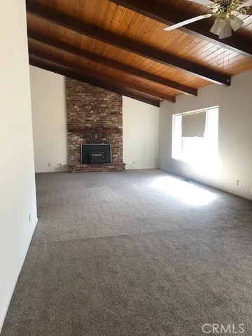a view of empty room with a fireplace