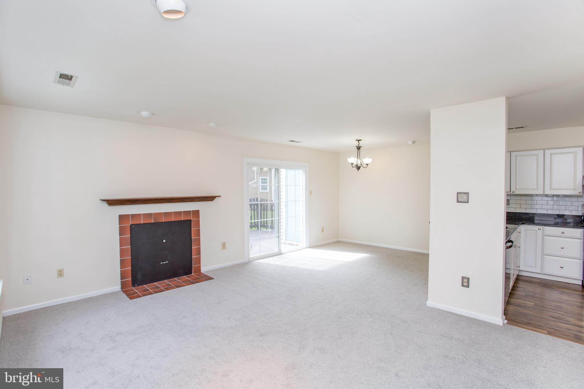 144 Carousel Circle Doylestown, PA 18901 - Photo 16 of 40 an empty room with a fireplace and cabinet