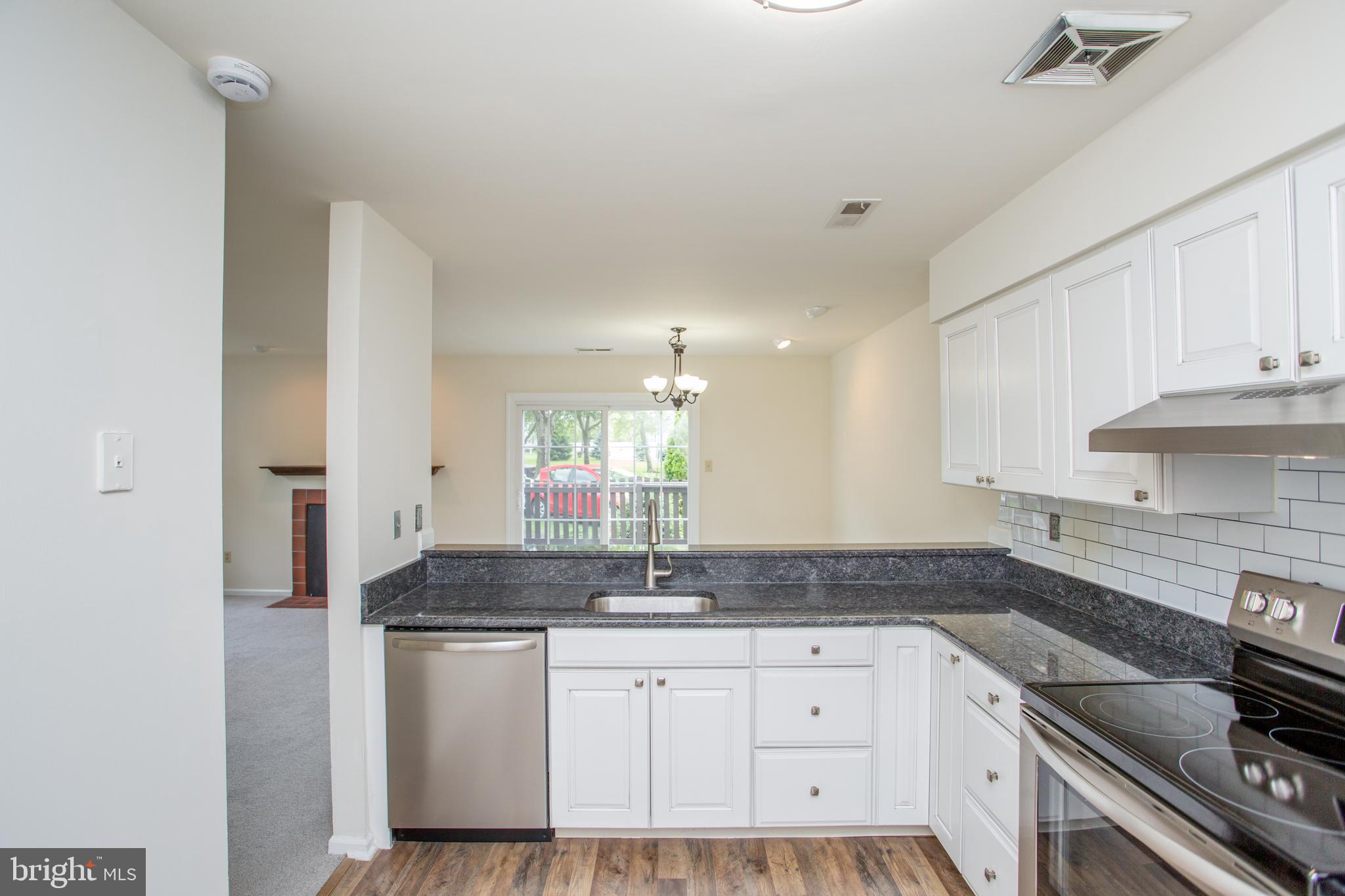 144 Carousel Circle Doylestown, PA 18901 - Photo 21 of 40 a kitchen with granite countertop a sink stainless steel appliances and cabinets