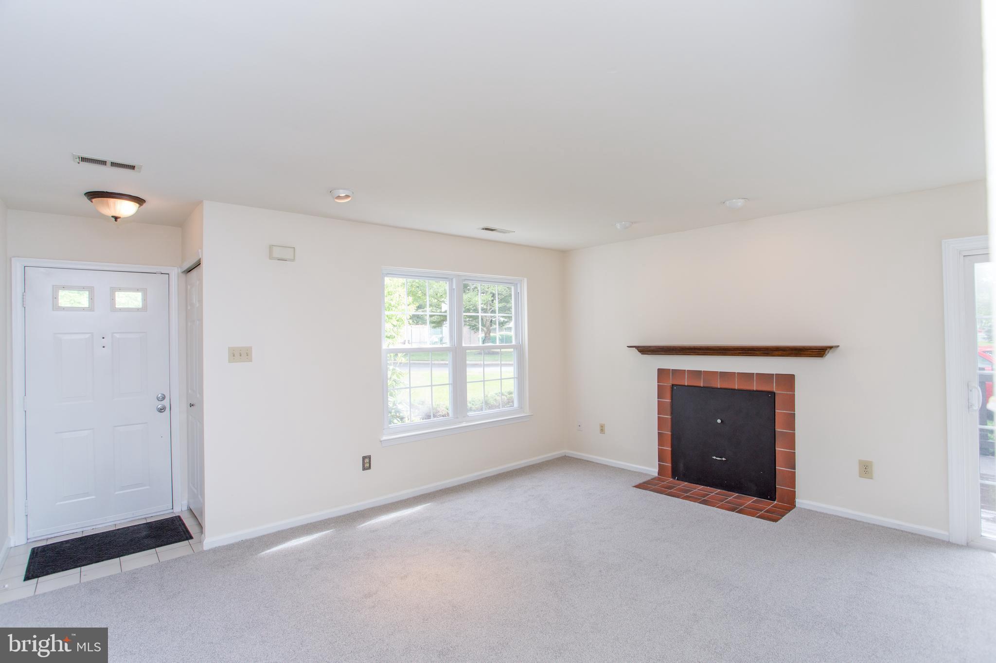 144 Carousel Circle Doylestown, PA 18901 - Photo 3 of 40 an empty room with a fireplace and windows