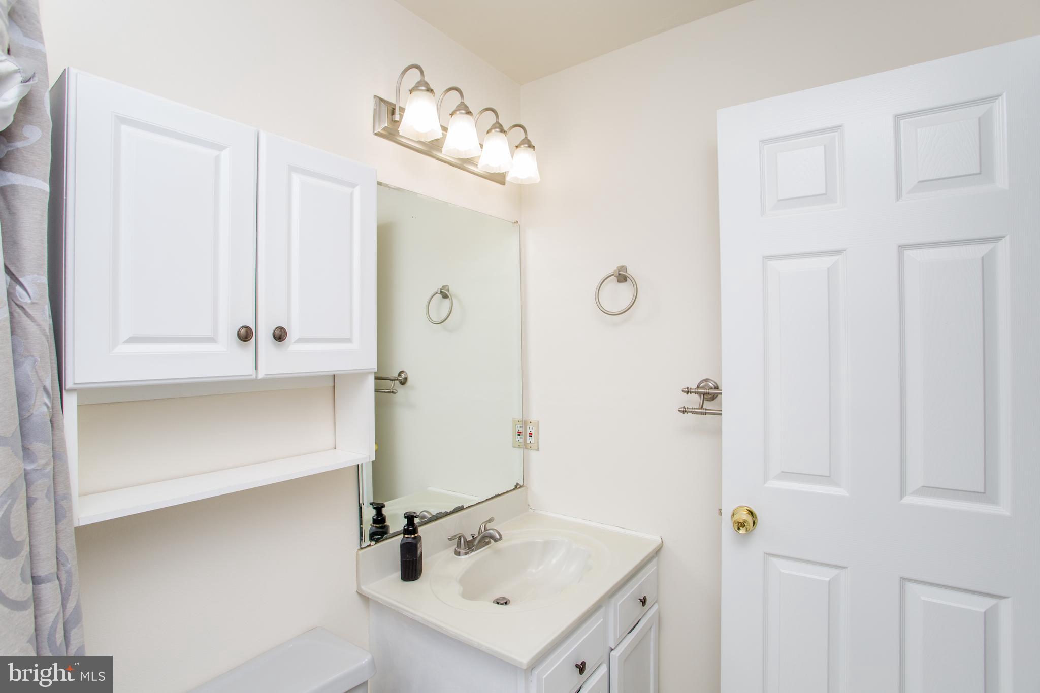 144 Carousel Circle Doylestown, PA 18901 - Photo 35 of 40 a bathroom with a sink mirror and vanity