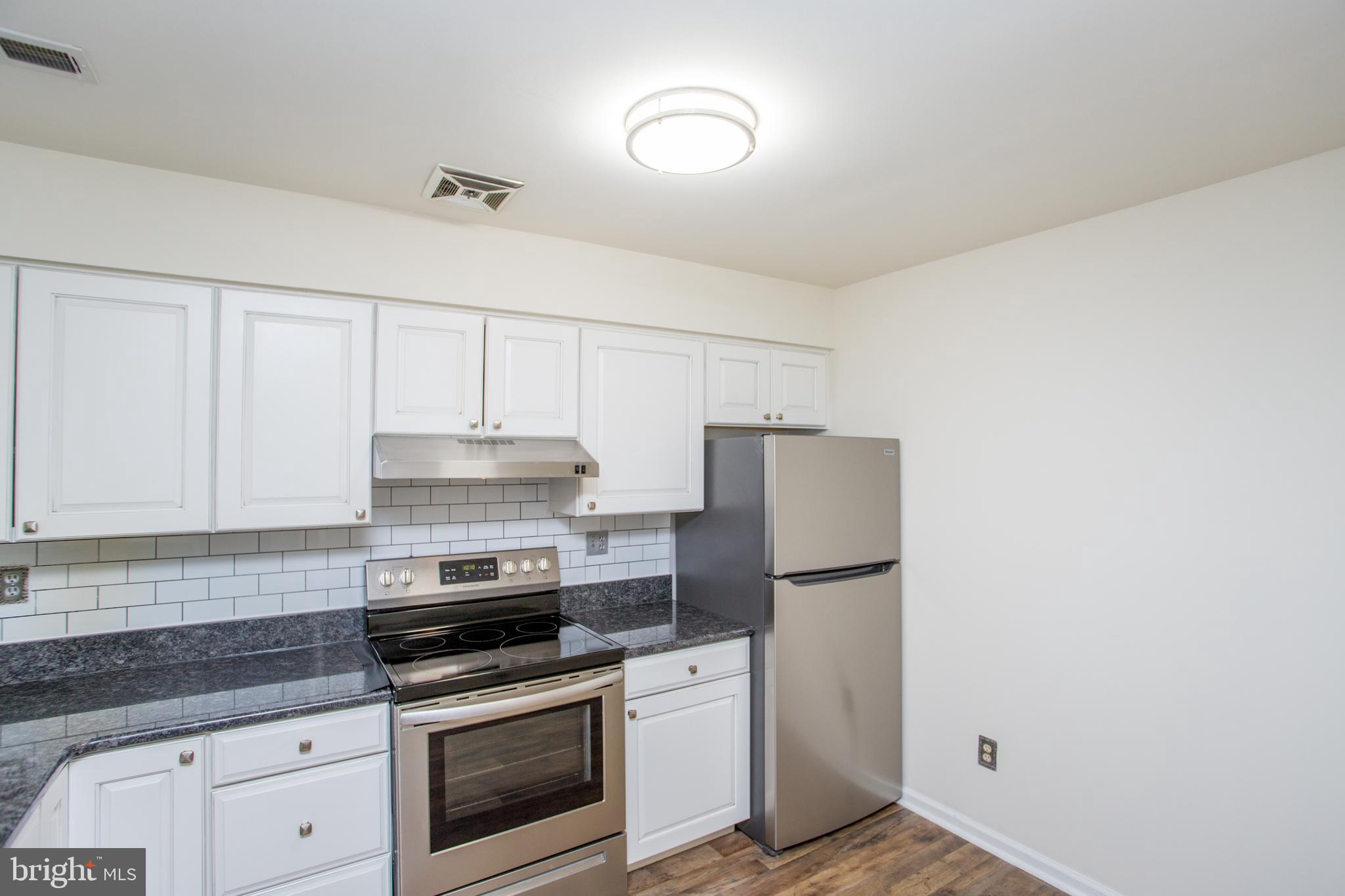 144 Carousel Circle Doylestown, PA 18901 - Photo 6 of 40 a kitchen with a stove and a refrigerator