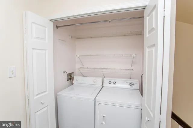 a view of storage and utility room with washer and dryer