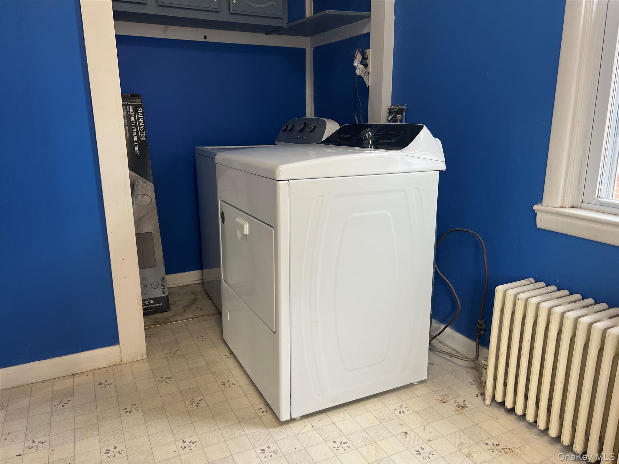 3 Davis Road Poughkeepsie, NY 12603 - Photo 22 of 34 Laundry room with tile patterned floors, radiator heating unit, and washer and dryer