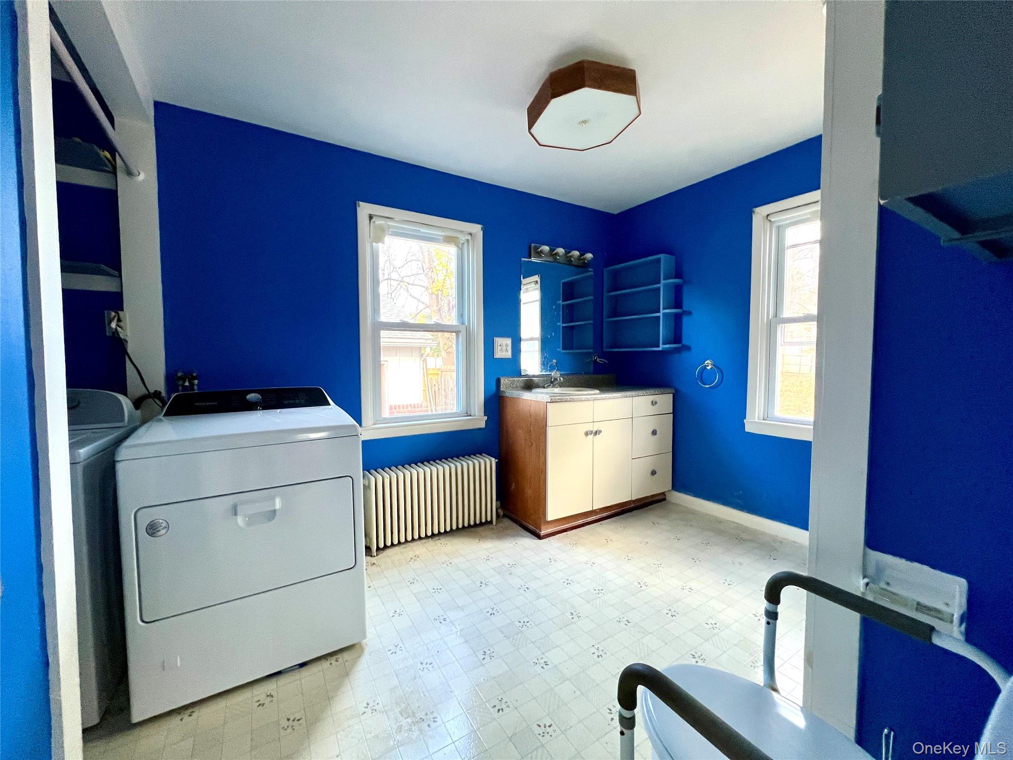 3 Davis Road Poughkeepsie, NY 12603 - Photo 24 of 34 Laundry room featuring light floors, radiator heating unit, and washing machine and dryer